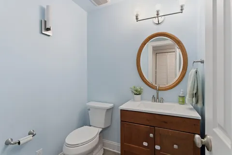 a bathroom with a sink a mirror and a toilet