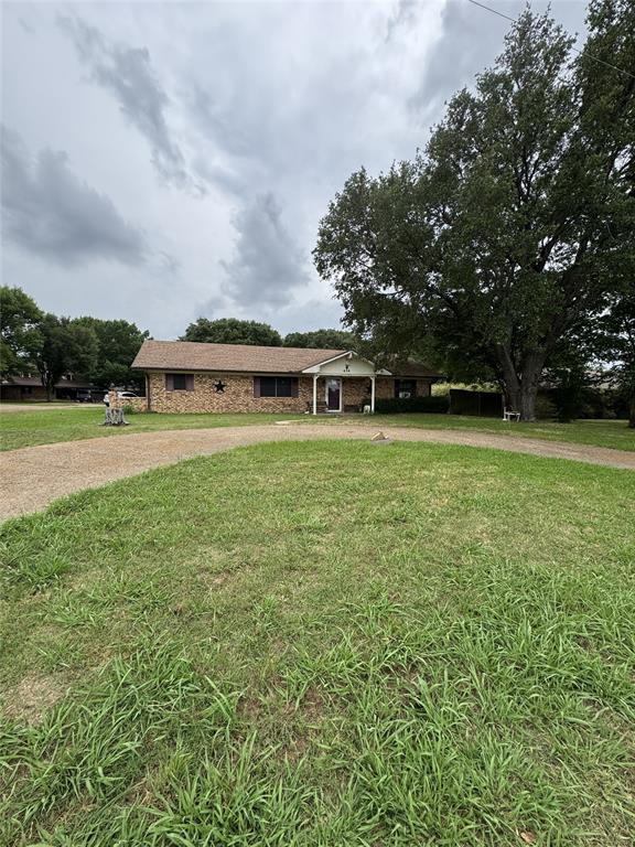 636 East Kempner Street Mabank, TX 75147 - Photo 5 of 28 Brick exterior residence featuring a covered front entry and a large mature tree