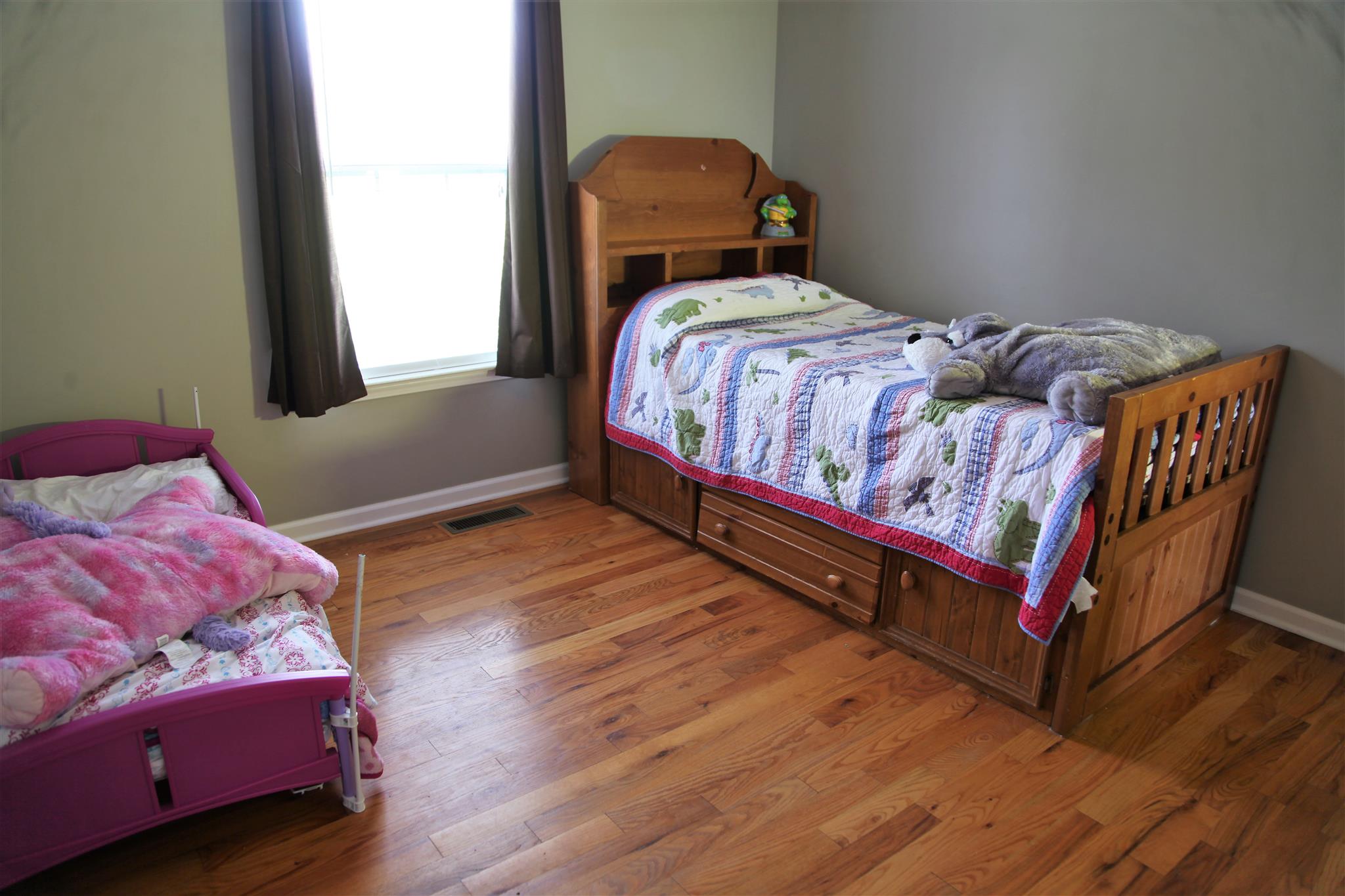 127 Old Martin Chapel Road Portland, TN 37148 - Photo 12 of 15 a bedroom with a bed and wooden floor