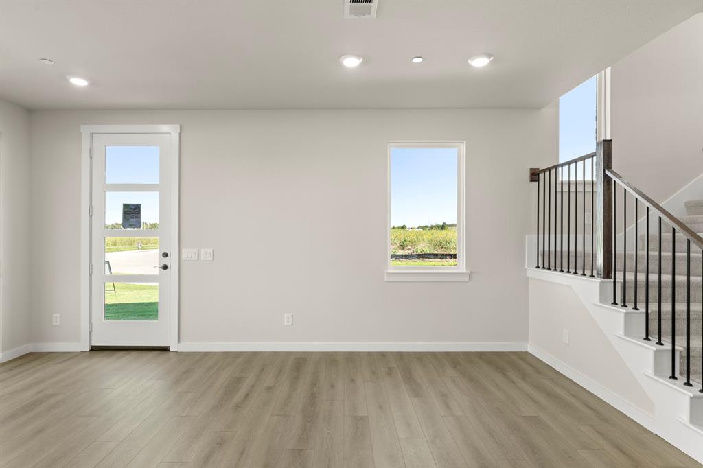2001 Aldrich Road Celina, TX 75009 - Photo 12 of 37 an empty room with wooden floor and windows