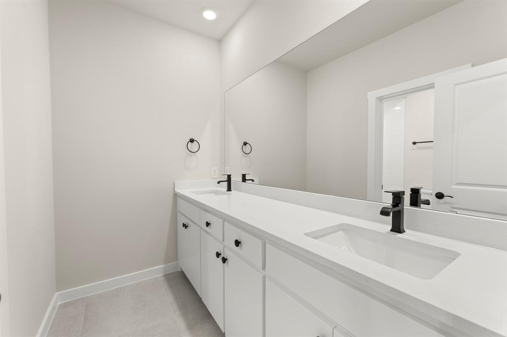 2001 Aldrich Road Celina, TX 75009 - Photo 23 of 37 a bathroom with a sink and a mirror