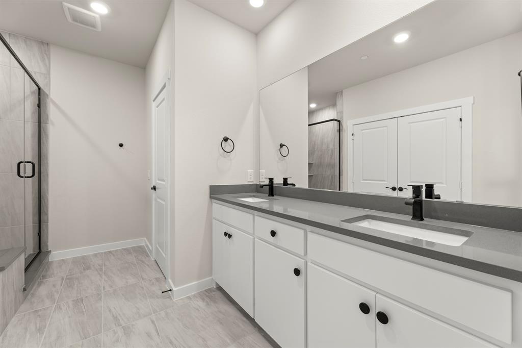 2001 Aldrich Road Celina, TX 75009 - Photo 29 of 37 a bathroom with a granite countertop sink and a mirror