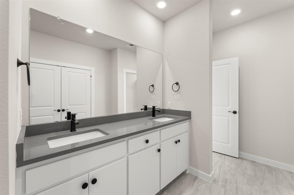 2001 Aldrich Road Celina, TX 75009 - Photo 33 of 37 a bathroom with a sink and a mirror