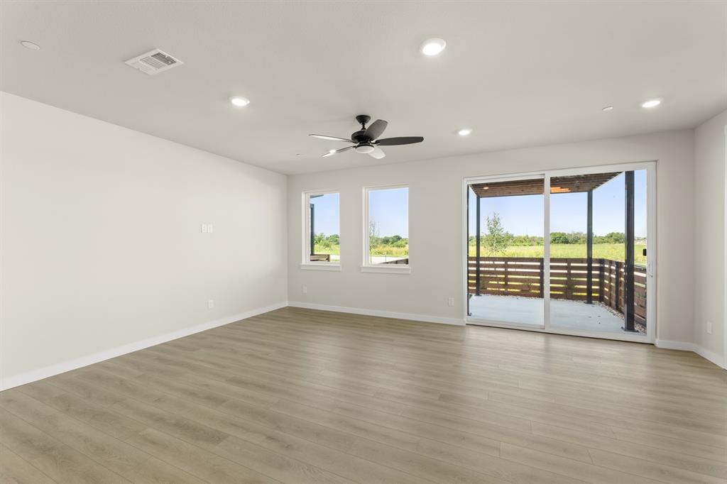 2001 Aldrich Road Celina, TX 75009 - Photo 8 of 37 an empty room with wooden floor and windows