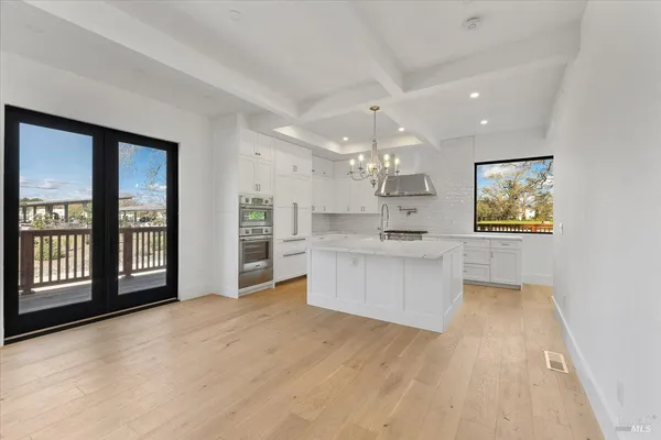 a kitchen with a stove and a white cabinet
