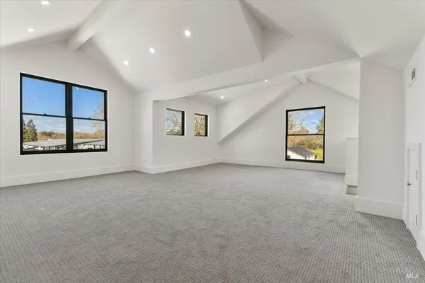 an empty room with windows and closet