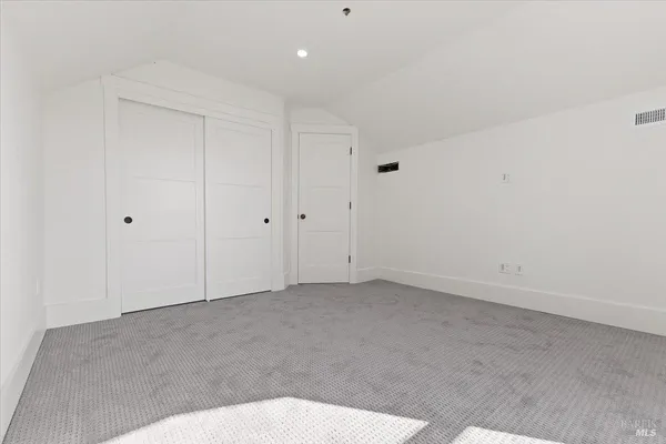 a kitchen with white cabinets and appliances