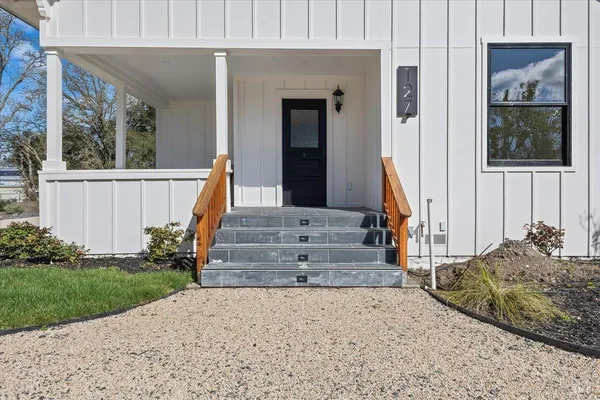 a front view of a house with a yard