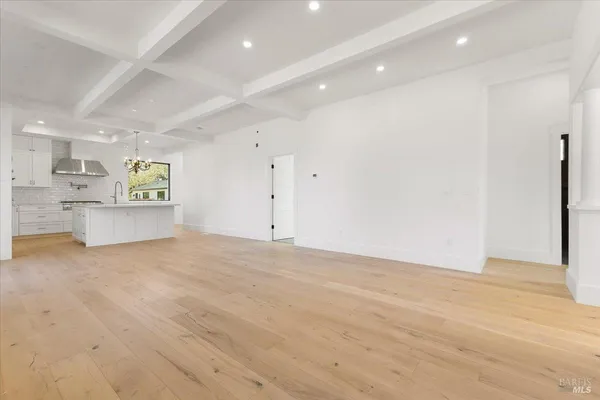 an empty room with windows and fireplace