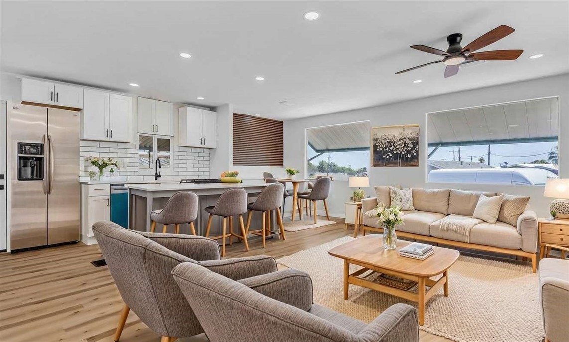a living room kitchen with furniture and a view of kitchen
