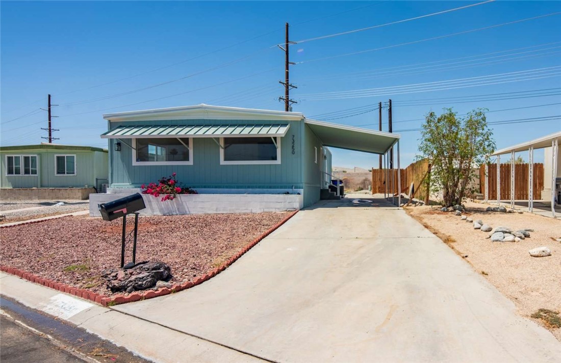 73250 Colonial Drive Thousand Palms, CA 92276 - Photo 16 of 18 a front view of a house with garden