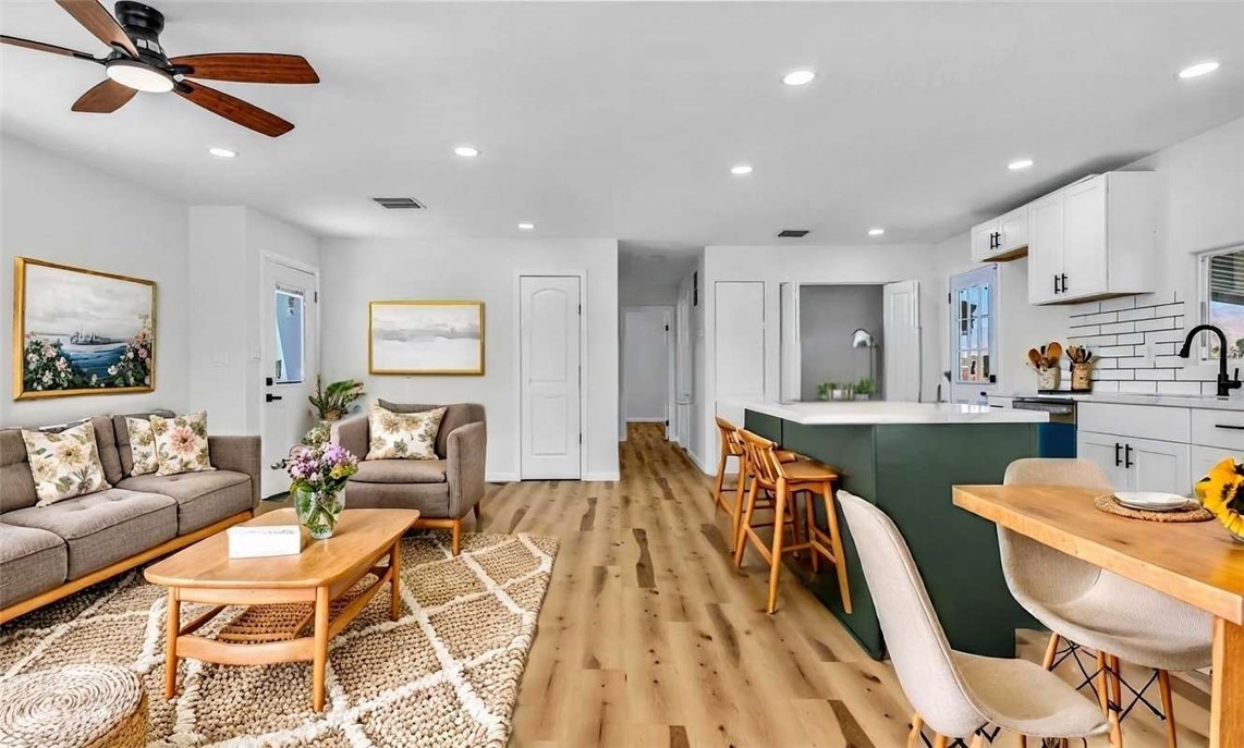 73250 Colonial Drive Thousand Palms, CA 92276 - Photo 2 of 18 a living room with dining room and wooden floor