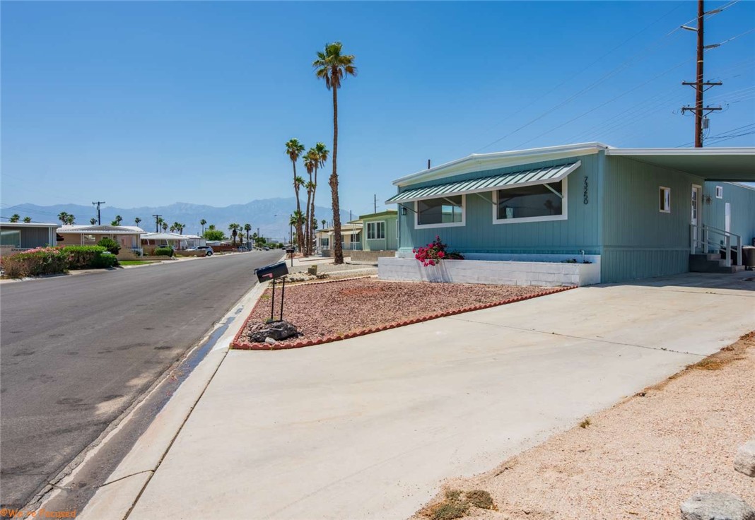 73250 Colonial Drive Thousand Palms, CA 92276 - Photo 3 of 18 a front view of a house with a yard