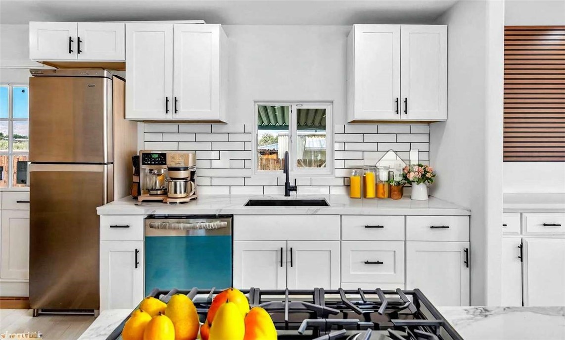 73250 Colonial Drive Thousand Palms, CA 92276 - Photo 5 of 18 a kitchen with stainless steel appliances granite countertop a refrigerator sink and stove