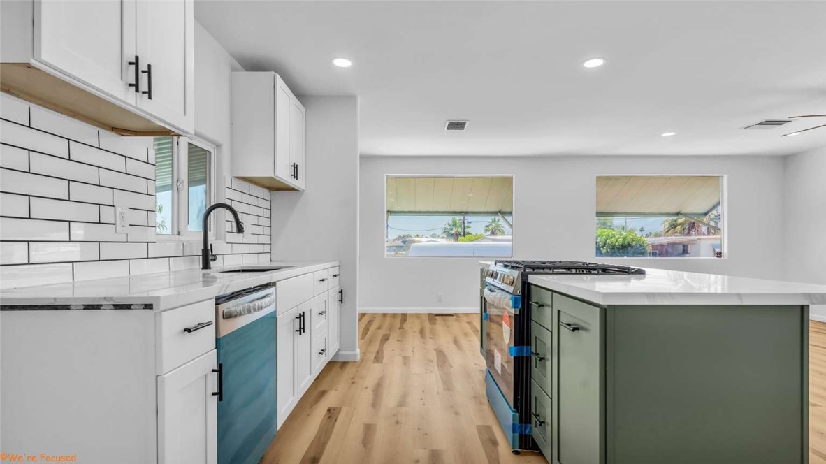 73250 Colonial Drive Thousand Palms, CA 92276 - Photo 6 of 18 a kitchen with a sink stove and cabinets