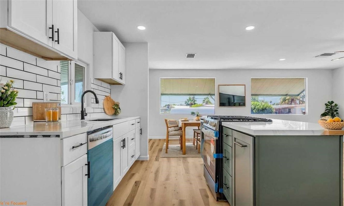 73250 Colonial Drive Thousand Palms, CA 92276 - Photo 7 of 18 a kitchen with a sink stove and cabinets
