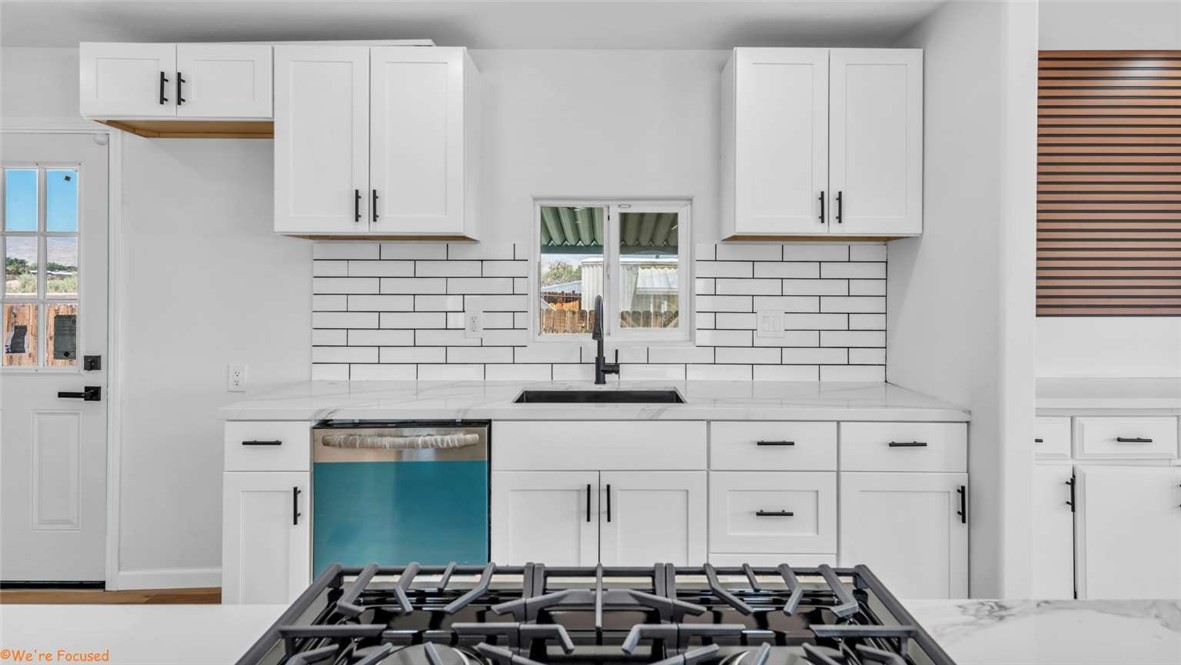 73250 Colonial Drive Thousand Palms, CA 92276 - Photo 10 of 18 a kitchen with granite countertop a sink and cabinets