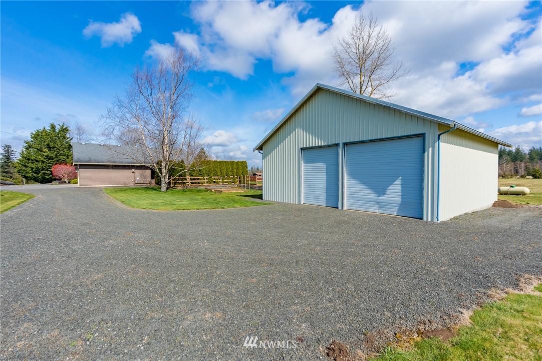 5434 Noon Road Bellingham, WA 98226 - Photo 11 of 40 a view of a house with backyard and trees