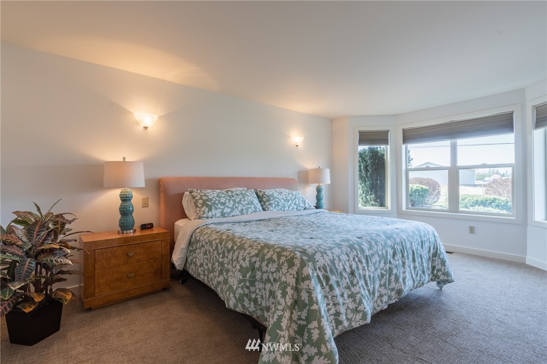 5434 Noon Road Bellingham, WA 98226 - Photo 27 of 40 a bed sitting in a bedroom next to a window