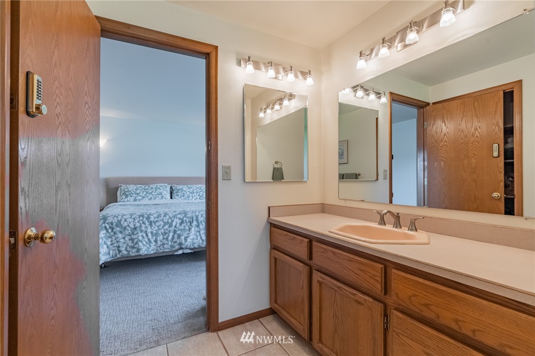 5434 Noon Road Bellingham, WA 98226 - Photo 28 of 40 a en suite bathroom with a double vanity sink and mirror