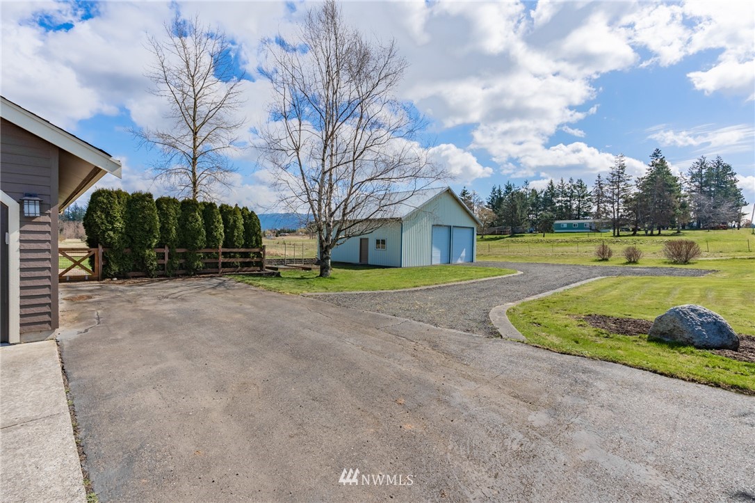 5434 Noon Road Bellingham, WA 98226 - Photo 10 of 40 a view of a house with a yard and garage