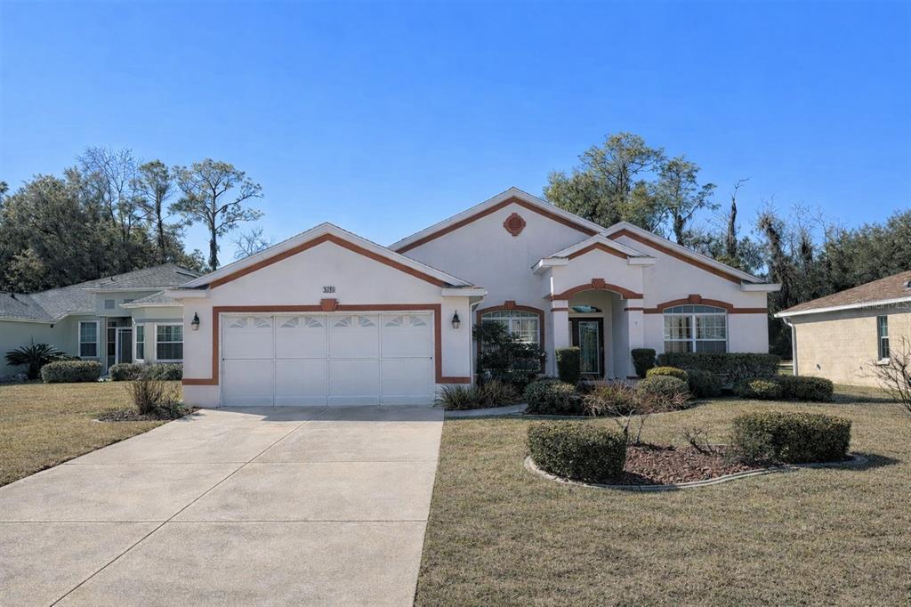 a front view of a house with a yard and garage