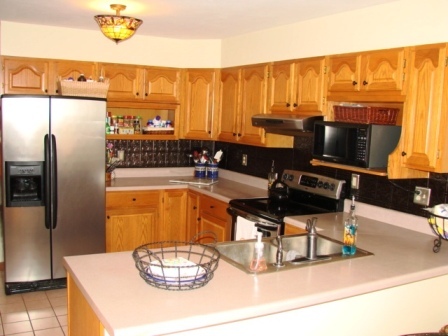 131 London Ridge Road Boones Mill, VA 24065 - Photo 2 of 37 a room with stainless steel appliances a dining table and a chandelier