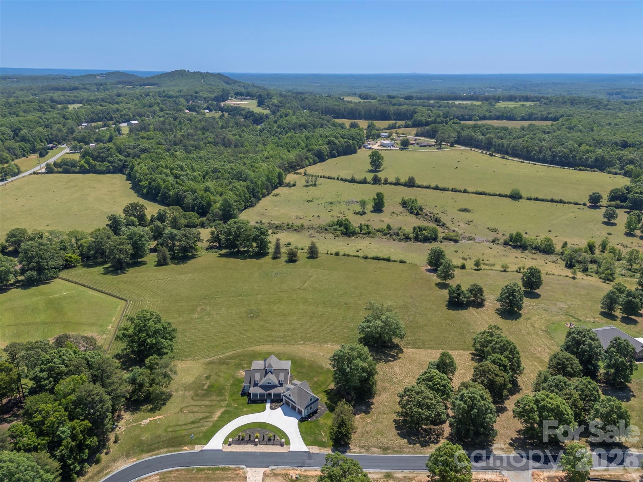 297 Mountain Meadows Lane, Unit 7 Tryon, NC 28782 - Photo 46 of 47 an aerial view of a house with a lake view