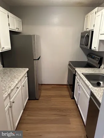 a kitchen with a sink stove and refrigerator