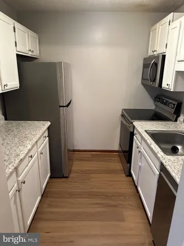 a kitchen with a sink stove and refrigerator