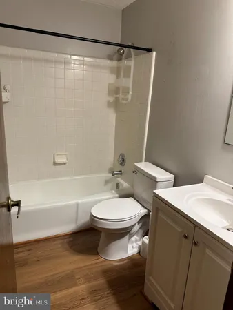 a bathroom with a sink a toilet a mirror and shower