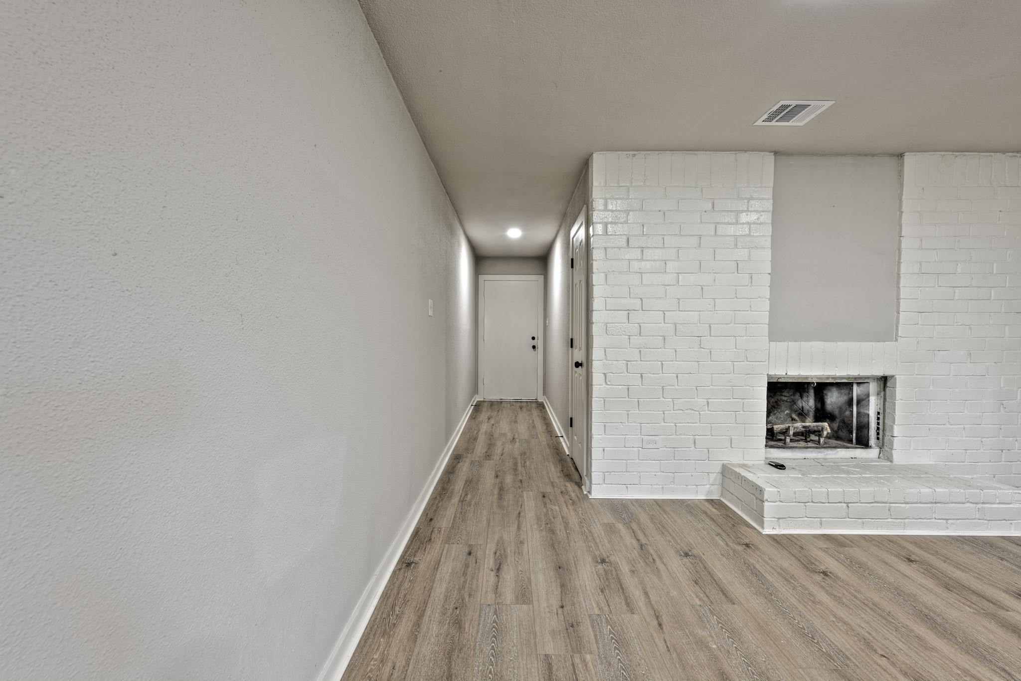 4926 Adonis Drive Spring, TX 77373 - Photo 4 of 16 a view of empty room with wooden floor and fireplace