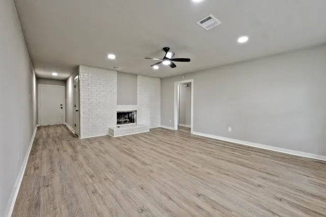 a view of an empty room with a kitchen