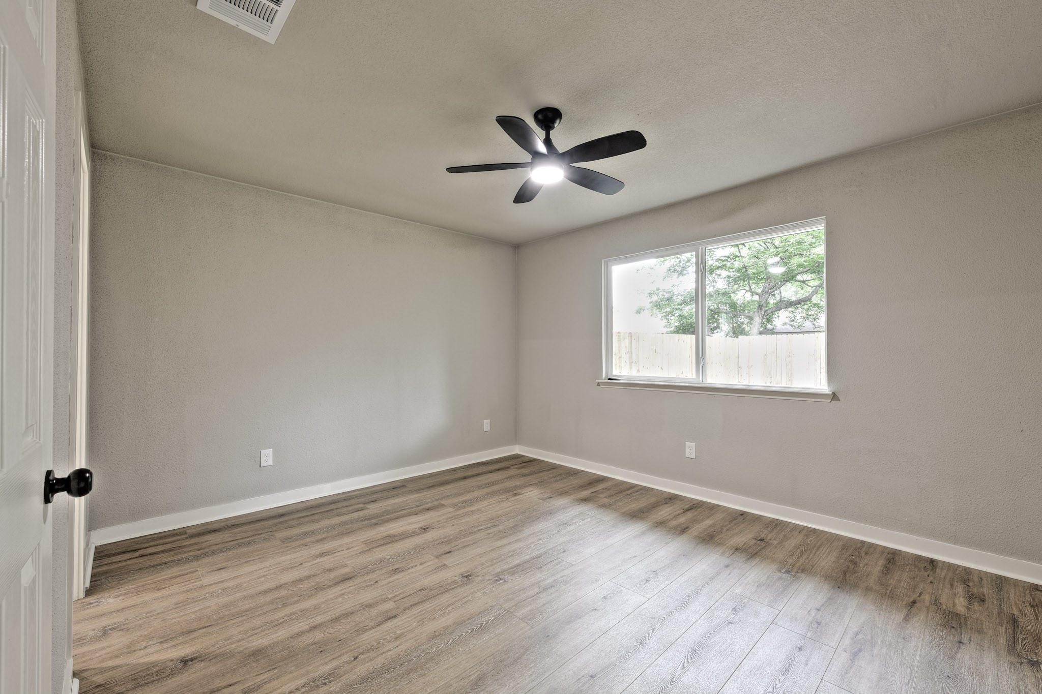 4926 Adonis Drive Spring, TX 77373 - Photo 9 of 16 a view of an empty room with wooden floor and a window