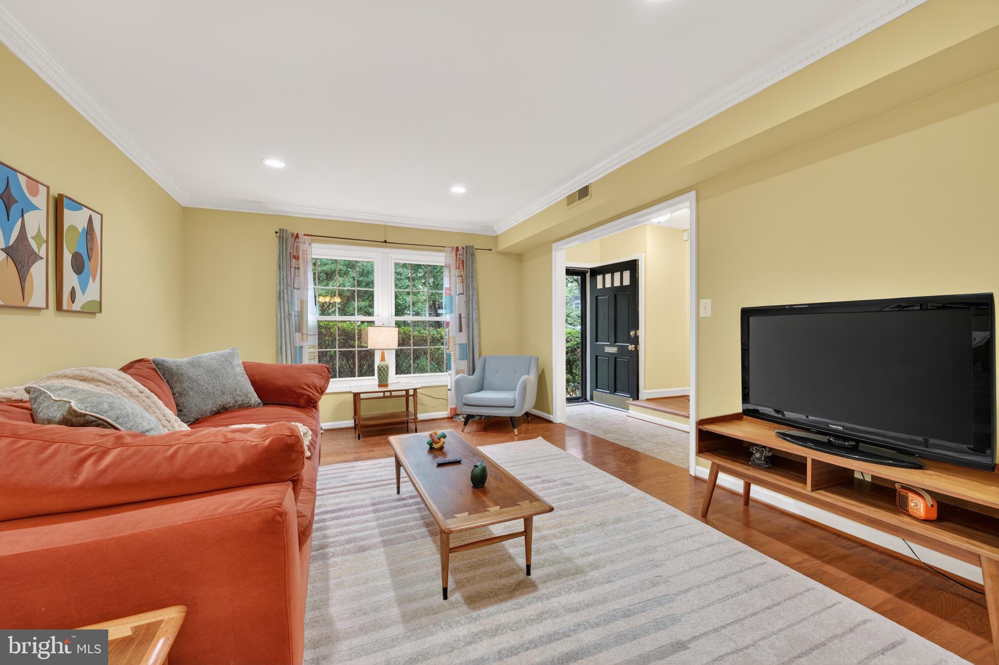 8139 Carrleigh Parkway Springfield, VA 22152 - Photo 2 of 27 a living room with furniture and a flat screen tv