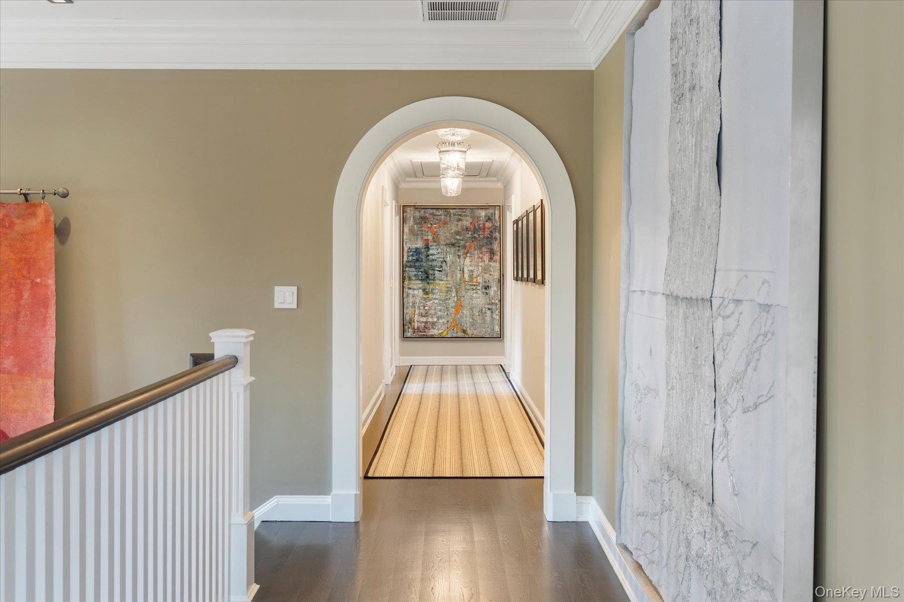 231 Flying Point Road Southampton, NY 11968 - Photo 28 of 34 Hall featuring crown molding, dark wood-type flooring, and arched walkways