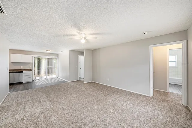 a view of a room with a stylish ceiling fan and entryway