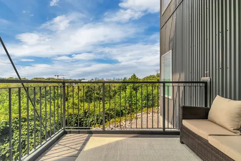 a view of a balcony with furniture