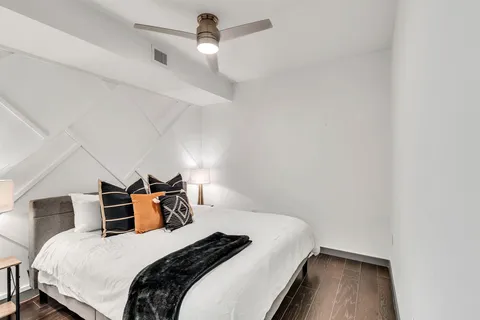 a bedroom with a bed and a ceiling fan