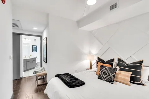 a bedroom with furniture and a wooden floor