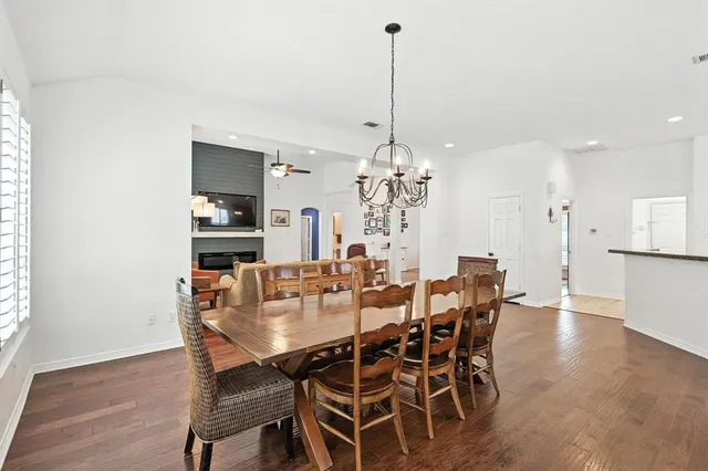 a view of a dining room with furniture wooden floor and chandelier
