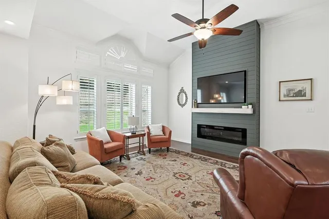 a living room with furniture fireplace and a flat screen tv