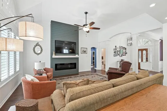 a living room with furniture a fireplace and a flat screen tv