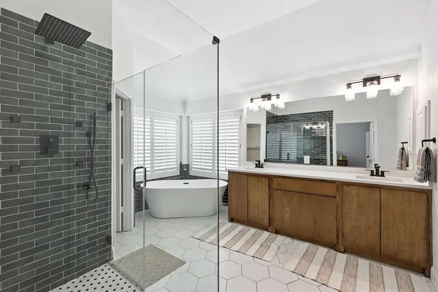 a bathroom with a tub sink and mirror