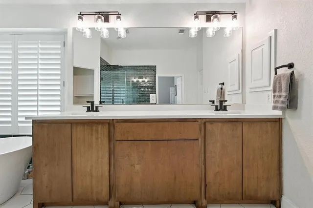 a bathroom with a double vanity sink and a mirror