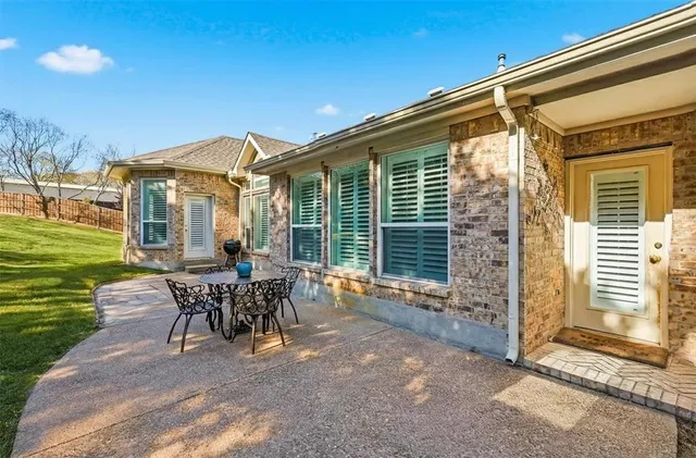 a view of a house with backyard porch and sitting area