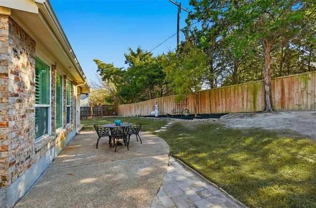a view of a back yard of the house with a patio
