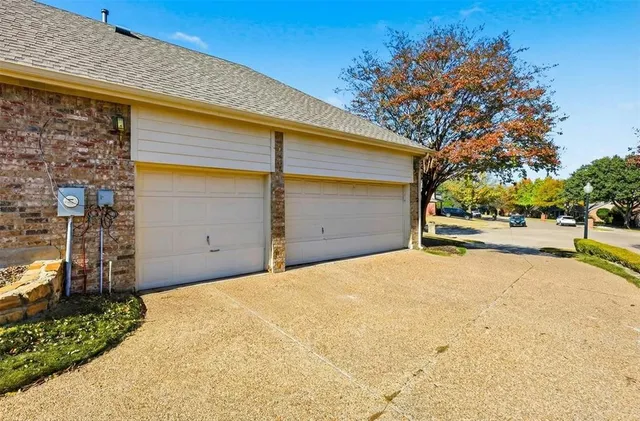 a view of garage with large tree
