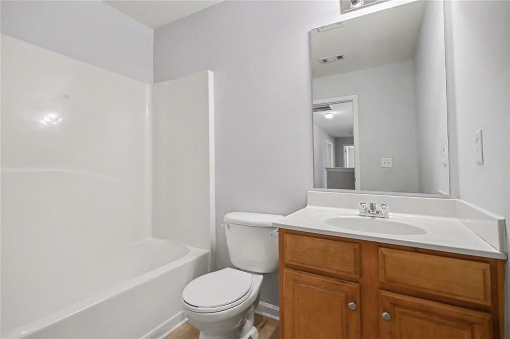 4350 Defoors Farm Trail Powder Springs, GA 30127 - Photo 20 of 35 a bathroom with a granite countertop sink toilet and shower