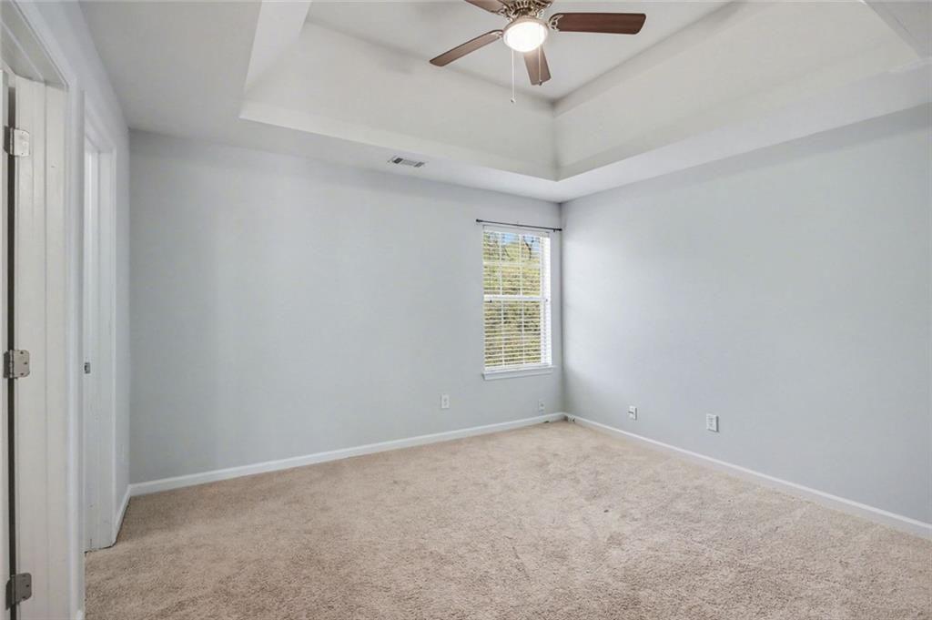 4350 Defoors Farm Trail Powder Springs, GA 30127 - Photo 21 of 35 an empty room with a chandelier fan and windows